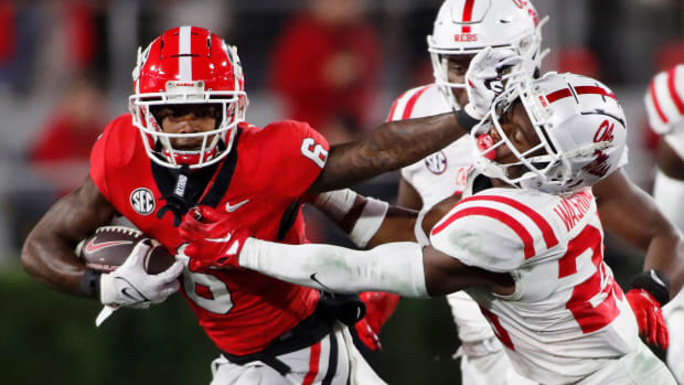Georgia wide receiver Dominic Lovett (6) stiff arms Ole Miss safety Trey Washington (25) during the first half of an NCAA college football game against Ole Miss in Athens, Ga., on Saturday, Nov. 11, 2023.